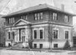 A black and white postcard of a square brick library with front columns