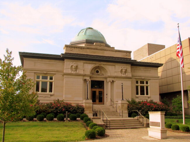 A limestone library with green domes roof