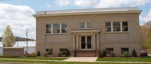 A tan library building with a flat roof