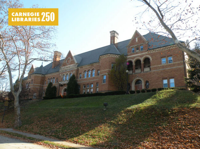 A red bricked library on a green hill