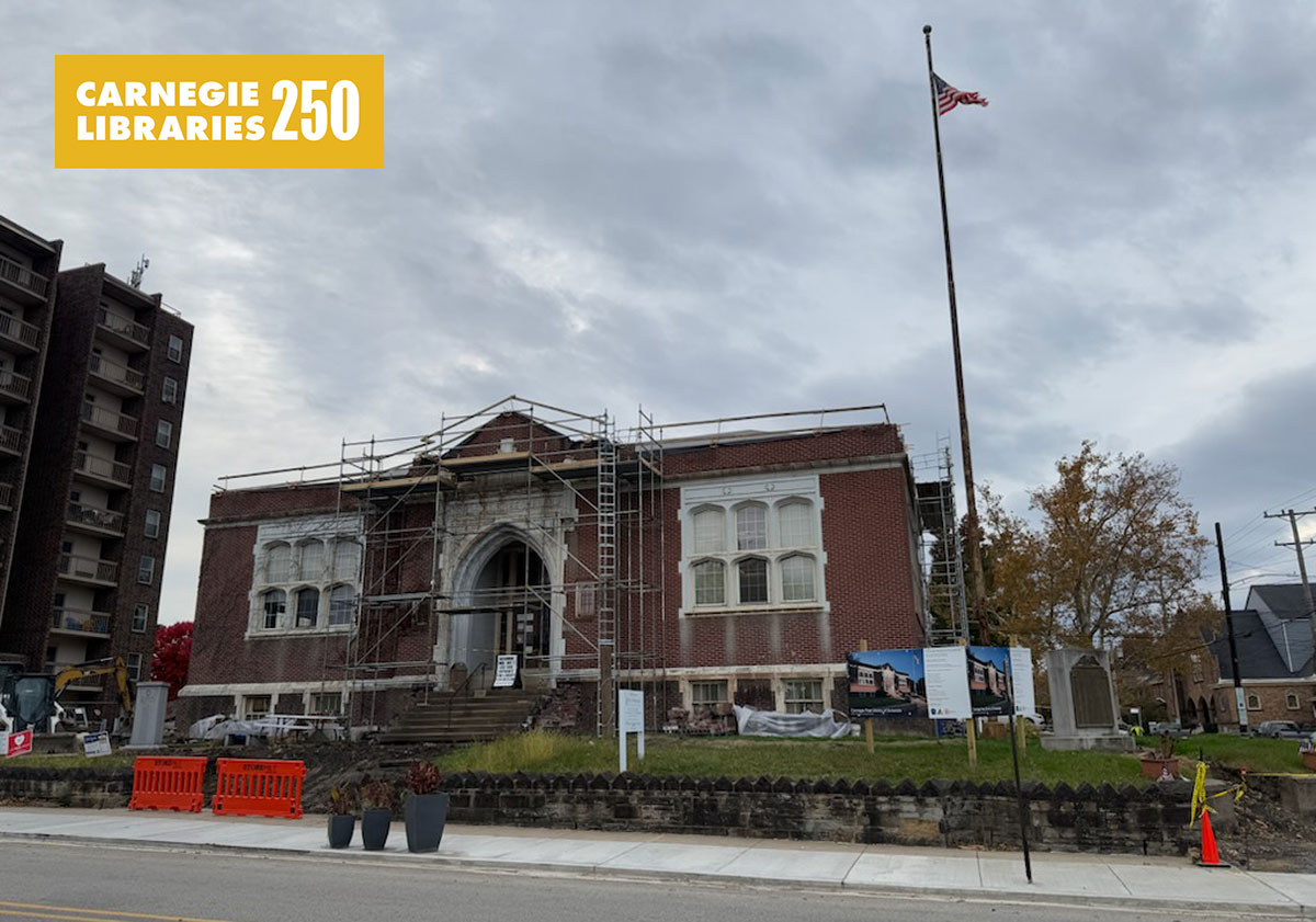 A red brick library building with scaffolding.