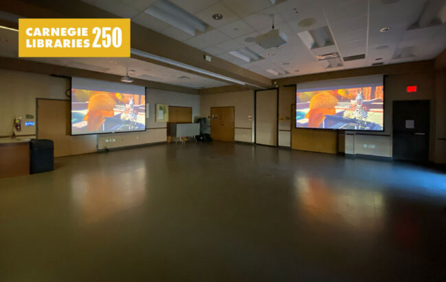 A room with two projector screens
