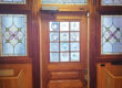A wooden door with stained glass