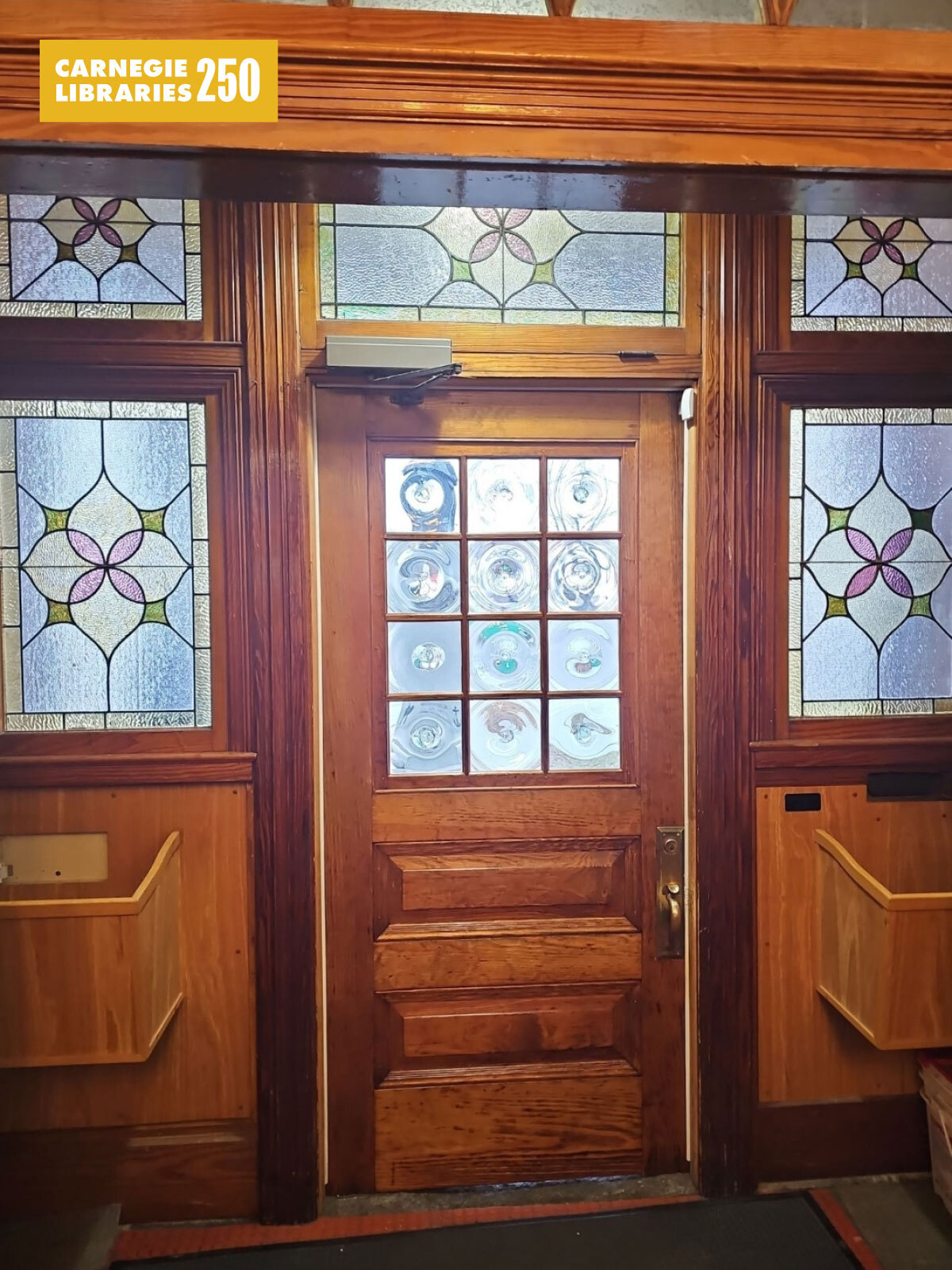 A wooden door with stained glass