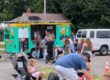 Parents and kids outside a food truck