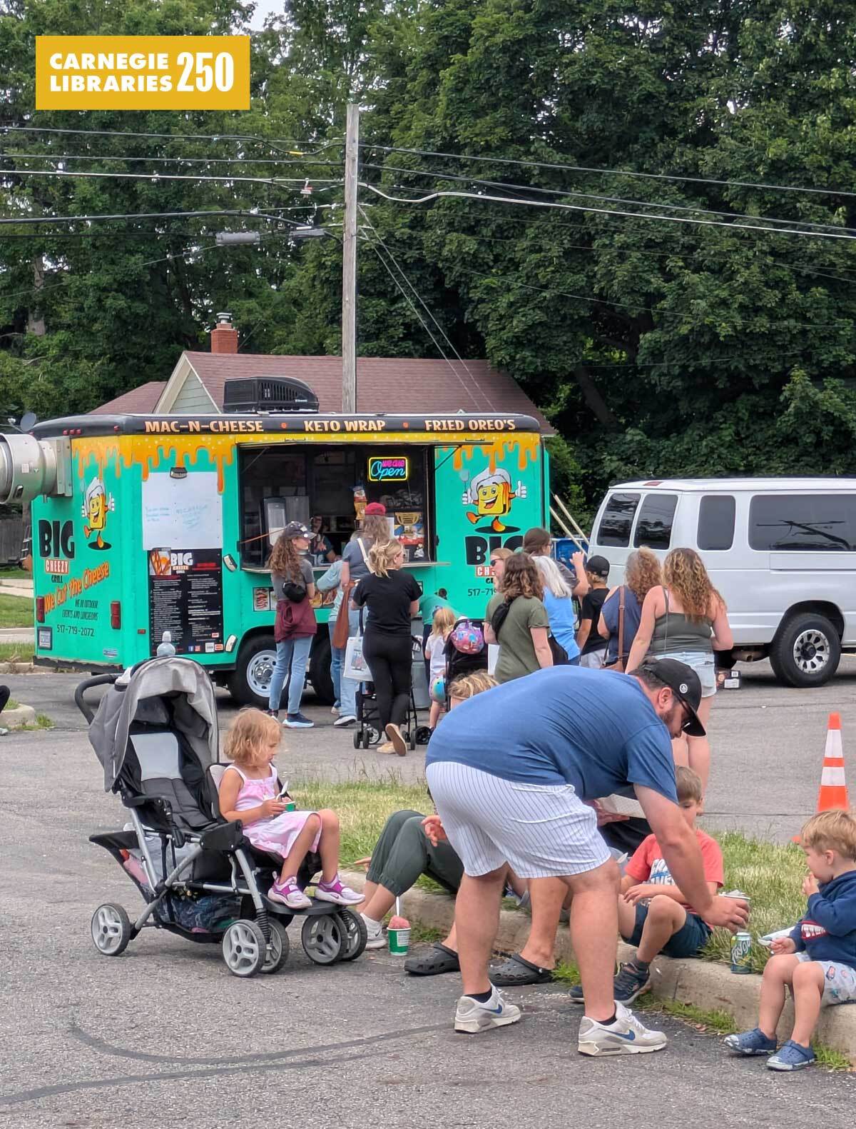 Parents and kids outside a food truck